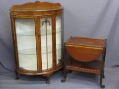 BOW FRONT TWIN DOOR CHINA CABINET on ball and claw feet and a mahogany tea trolley with flap sides