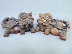 CHINESE CARVED WOOD TEMPLE LION WALL BRACKETS with bone teeth and glass inset eyes, 8cms H, 16cms