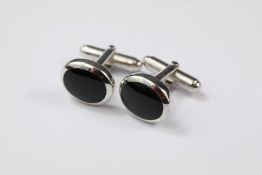 A Pair of Silver and Onyx Dress Cufflinks