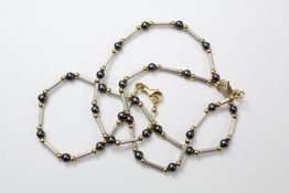 An 18ct Yellow and White Gold Pearl Necklace and Bracelet