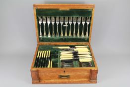 An Edwardian Oak Cased Silver Plated Canteen of Cutlery