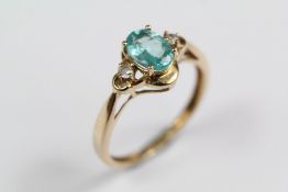 A 9ct Yellow Gold Aquamarine and White Stone Ring