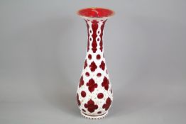 A Bohemian Cranberry and White Enamel Overlay Vase