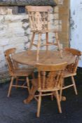 A Pine Circular Table and Four Chairs