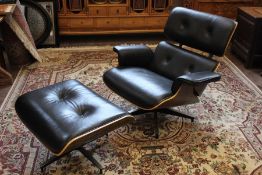 A Black Leather Eames-style Chair and Ottoman