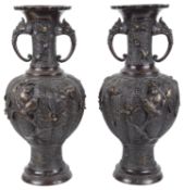 A pair of large decorative twin handled Japanese bronze vases