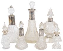 A small collection of Victorian and later glass and silver collared perfume bottles