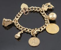 A yellow metal curb link charm bracelet