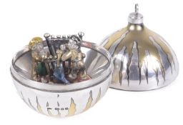 A parcel gilt, enamel and silver Stuart Devlin surprise Christmas bauble
