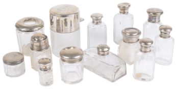 A collection of silver topped glass dressing table and vanity case jars and bottles