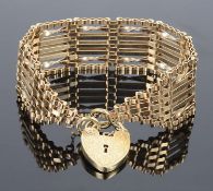 A fancy 9ct gold seven bar gate bracelet