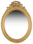 A large Edwardian oval gilt gesso wall mirror