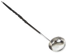 A Georgian style white metal and twisted baleen handle toddy ladle with white metal collar.