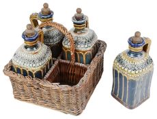 An unusual Doulton stoneware four decanter set in wicker basket