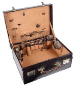 A vintage purple leather vanity case with silver topped glass bottles