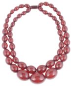 An Art Deco double row cherry amber bead necklace