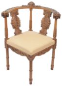 An early 20th century carved walnut corner armchair