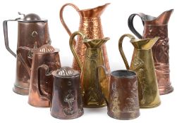 A collection of eight Arts and Crafts mostly Joseph Sankey & Son copper and brass ewers and jugs