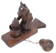 A contemporary Russian motion toy carved as bear washing a cub in a bath tub