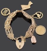 A 9ct gold fancy four bar gate bracelet and charms