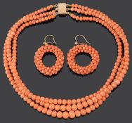 A three row natural coral bead necklace and coral hoop earrings