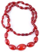 A single row necklace of graduated cherry amber beads