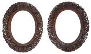 A pair of late 19th century Chinese Canton carved wood oval frames (2)