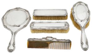 An Edward VII silver three piece silver backed dressing table set; others
