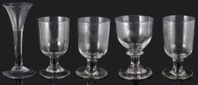 A mid 18th century wine glass and four 19th century pub rummers