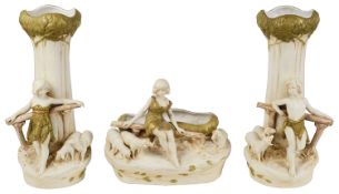 An Austrian Royal Dux blush ivory porcelain figural three piece garniture of vases