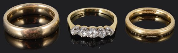 A five stone diamond set ring together with two wedding bands