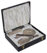 A modern silver four piece dressing table set
