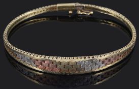 A contemporary three colour gold Italian woven gold bracelet