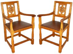 A pair of Wilf 'Squirrelman' Hutchinson oak elbow chairs