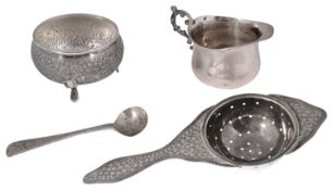 A Persian silver tea stainer and stand, a late Victorian small milk jug and a condiment spoon