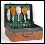 An early 20th Century silver vanity set consisting of two hair brushes, two clothes brushes, a