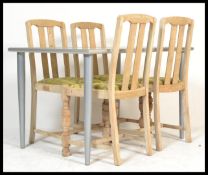 A set of 4 1930's oak dining chairs having contemporary upholstered drop in seats,railed back