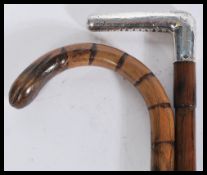 Two vintage walking stick canes comprising of a 19th Century Victorian example with silver