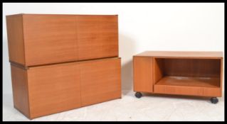 A retro 20th Century teak wood three piece modular wall unit in the manner of Avalon consisting of a