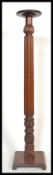 A 19th century Victorian mahogany torchere plant stand of tall form raised on tripod base with