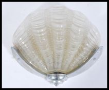 A mid 20th century Art Deco Odeon style frosted glass shell shaped porch wall light lamp being set