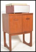 A vintage retro 20th Century teak wood music cabinet by Remploy raised on quadrille legs along