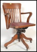 A 1930's Art Deco office Industrial factory swivel  desk chair having a shaped rail back with a