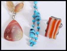 A vintage white metal and agate cabochon necklace and an agate ring marked silver together with a