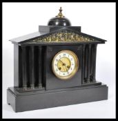 A Victorian 19th century slate and marble mantel clock. Raised on a plinth base with barrel dial and
