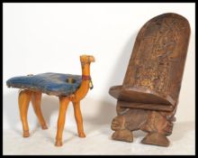 A 20th Century Camel stool modelled as a camel, fitted with a blue leather saddle together with a