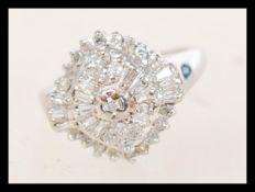 A 9ct white gold Art Deco style cluster ring having approx 50pts of diamonds in a typical Art Deco
