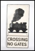 A reproduction cast iron railway Level Crossing sign. White, with black raised and painted notation.