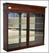A 19th century mahogany chemists apothecary - shop display hanging cabinet. Of solid mahogany