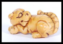 MEIJI PERIOD JAPANESE IVORY NETSUKE OF A CROUCHING